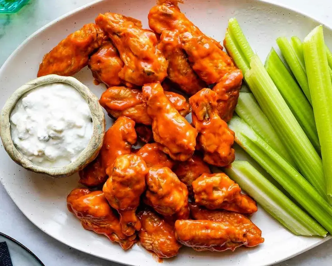 Buffalo wings served with celery and blue cheese